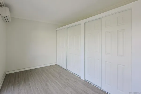 a view of a room with wooden floor