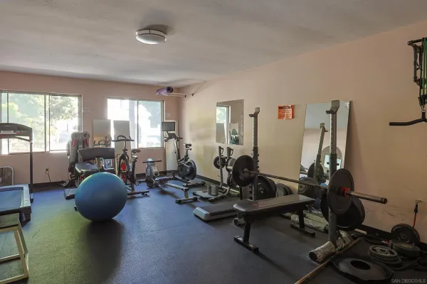 a room with gym equipment and windows