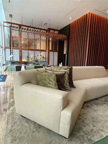 a living room with furniture and large window