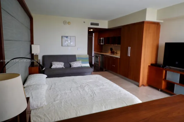 a bedroom with a bed and a television in it