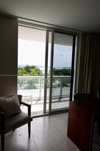 a view of a living room with balcony and furniture