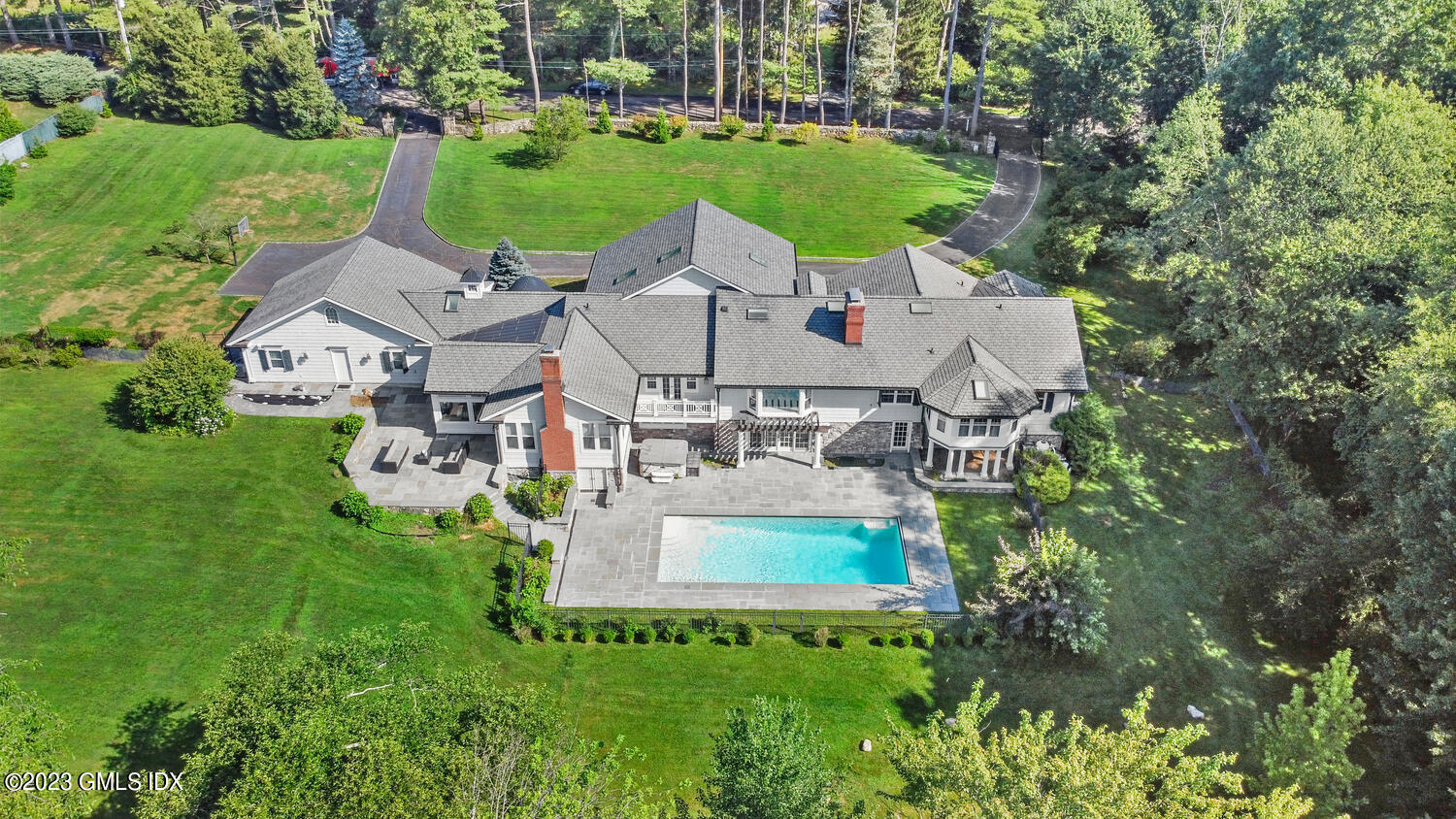 an aerial view of a house with outdoor space pool seating area and yard