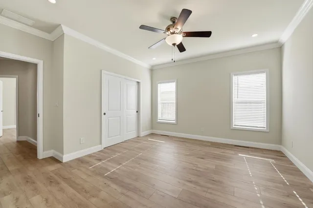 a view of an empty room with wooden floor