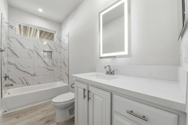 a bathroom with double vanity sink and a mirror