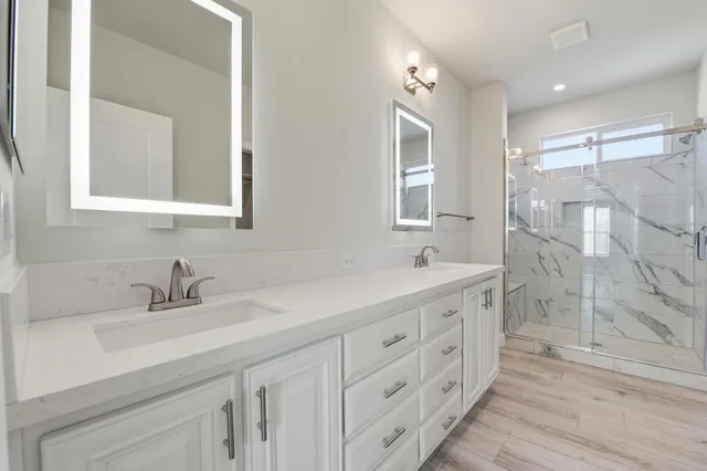 a bathroom with a sink vanity and a mirror