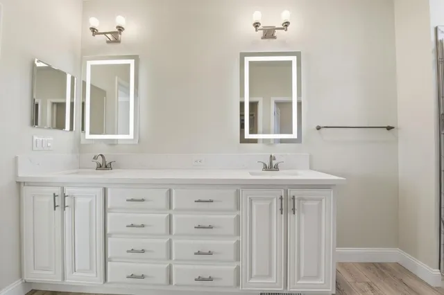 a bathroom with a granite countertop sink a toilet and shower