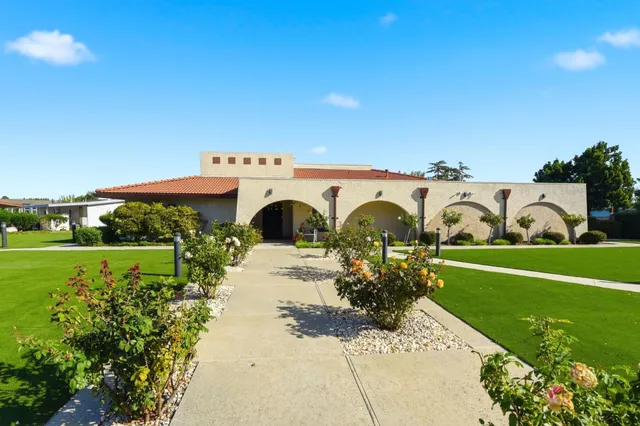 a living room with furniture and a book shelf