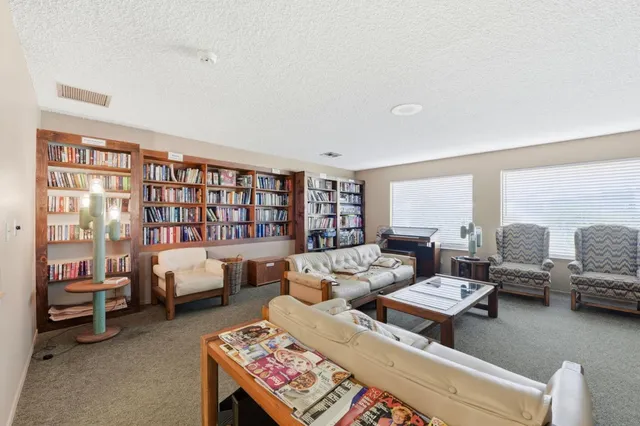 a large kitchen with kitchen island granite countertop a sink and cabinets