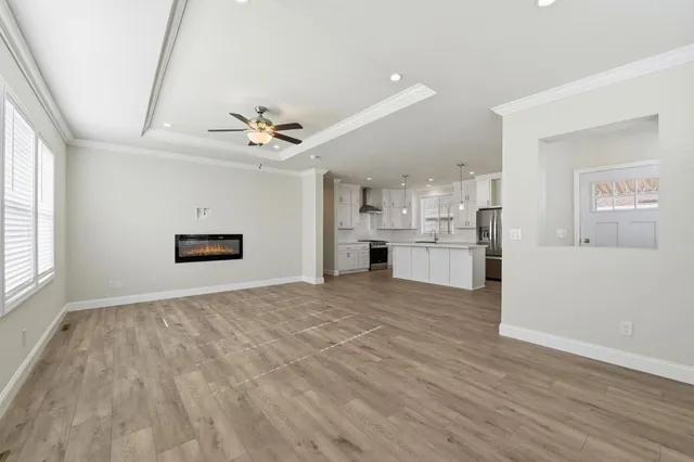 a view of kitchen with sink and refrigerator