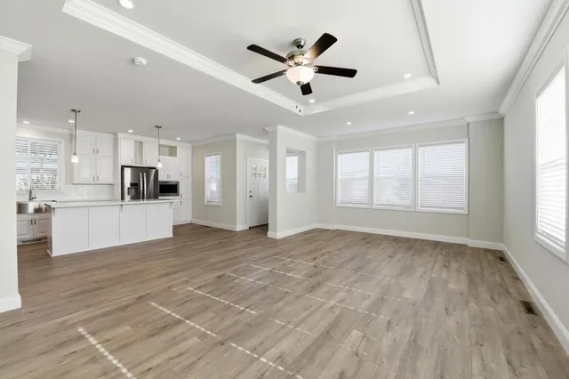 a view of an empty room with a kitchen