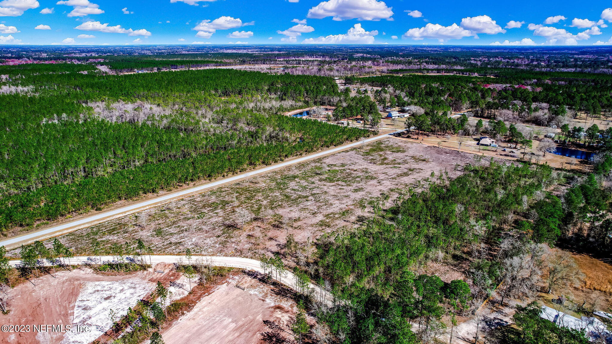 Lot 2 Rowe Road Hilliard, FL 32046 - Photo 7 of 9 a view of a yard with a wooden fence