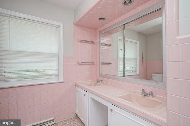 a bathroom with a sink a vanity and a mirror