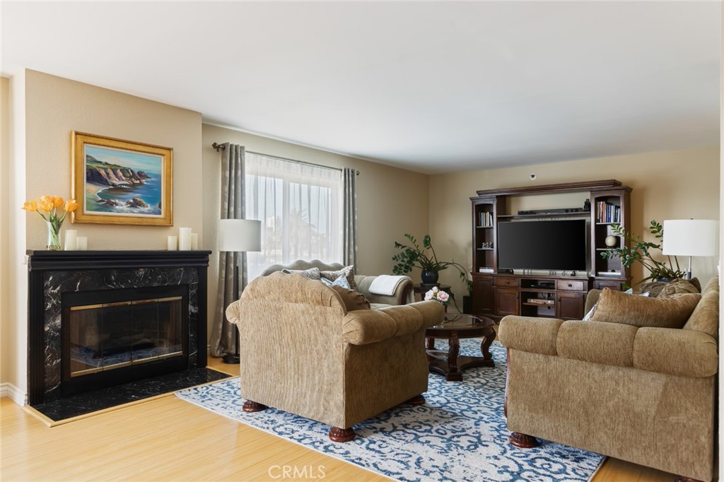 726 Elm Avenue, Unit 404 Long Beach, CA 90813 - Photo 12 of 31 a living room with furniture a flat screen tv and a fireplace