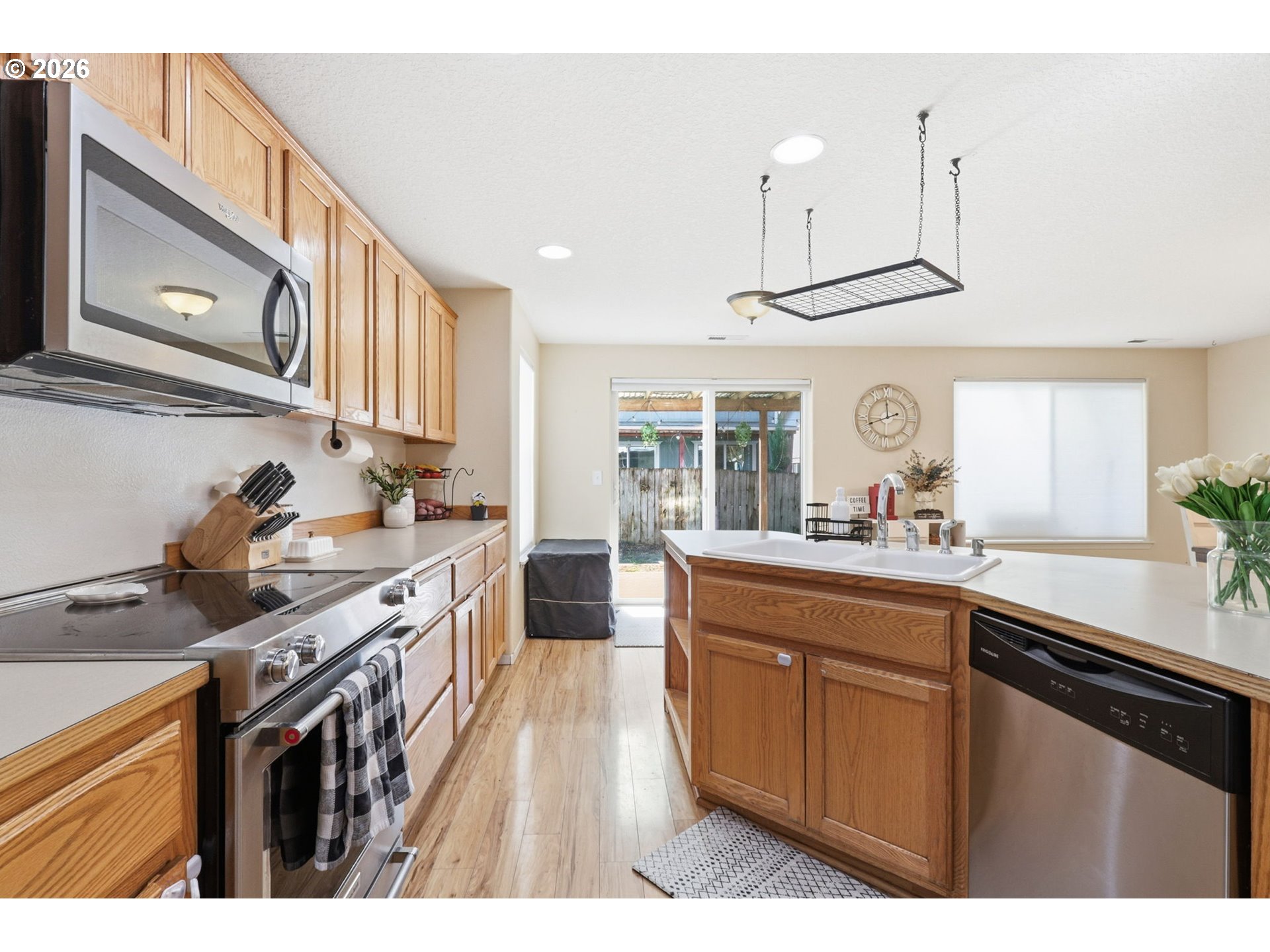 227 West 14th Street Lafayette, OR 97127 - Photo 13 of 36 a kitchen with stainless steel appliances granite countertop a sink a stove and a wooden cabinets