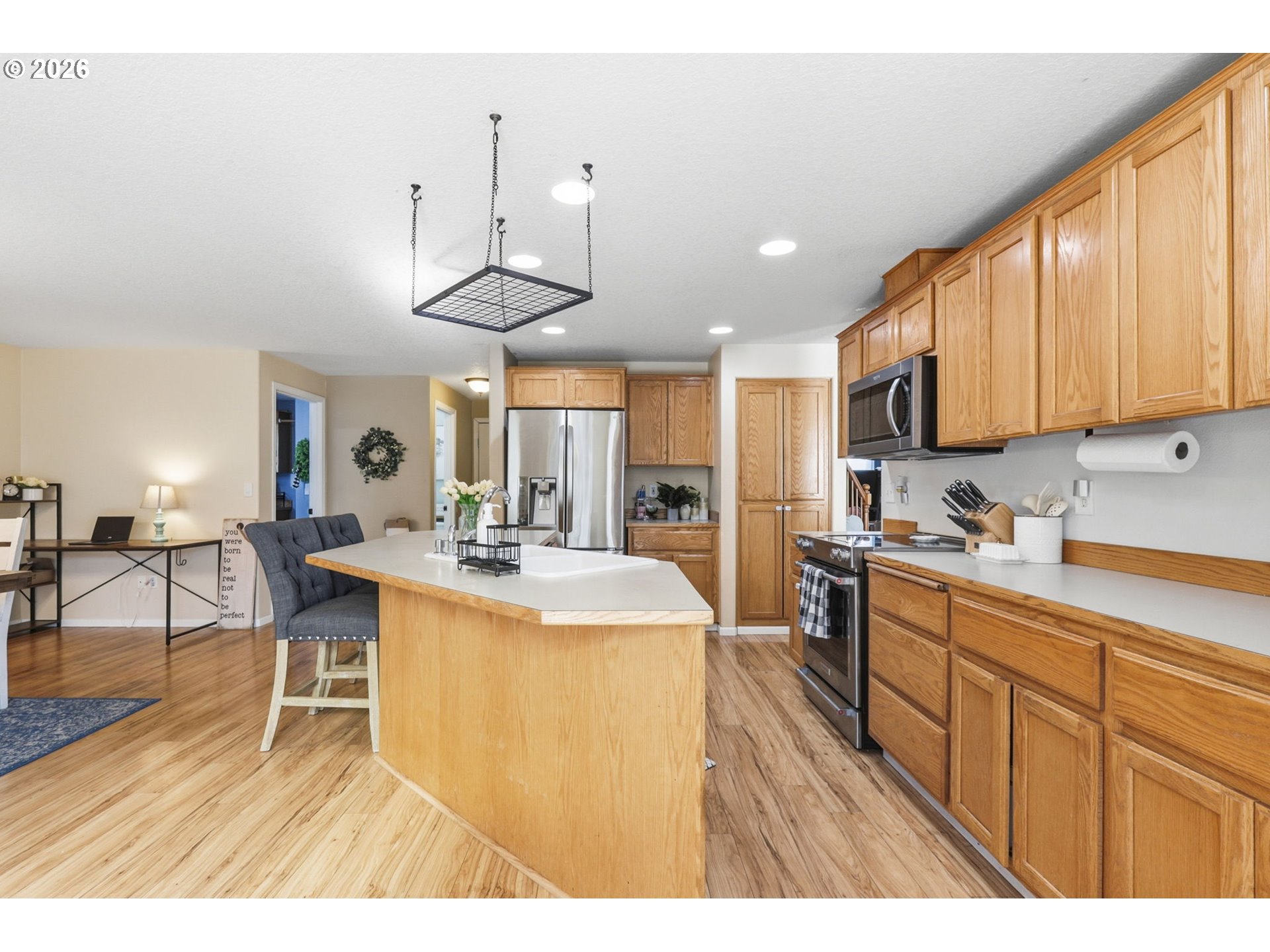 227 West 14th Street Lafayette, OR 97127 - Photo 18 of 36 a kitchen with stainless steel appliances kitchen island granite countertop a stove a sink a dining table and chairs