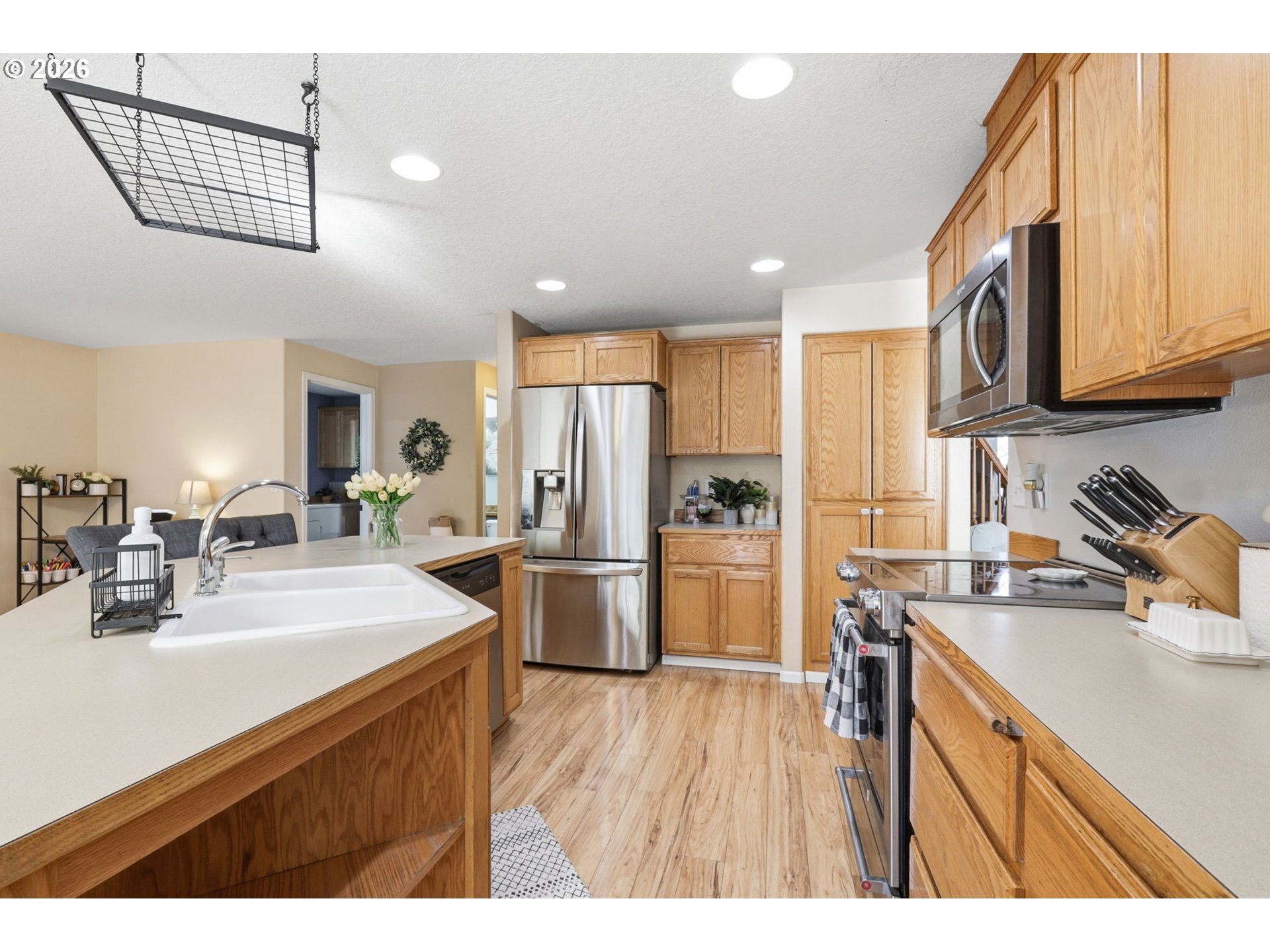 227 West 14th Street Lafayette, OR 97127 - Photo 19 of 36 a kitchen with a sink stainless steel appliances cabinets and a counter top space