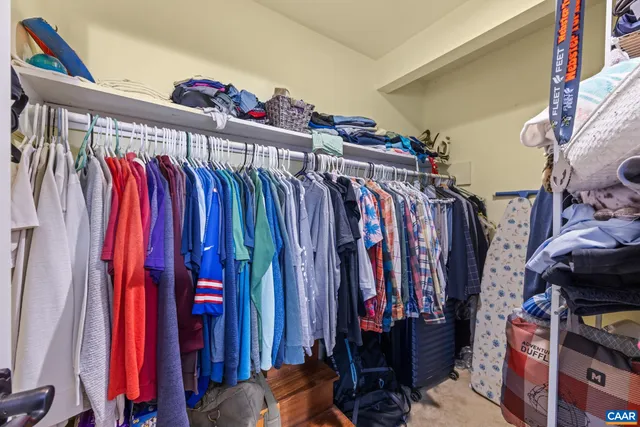 a view of walk in closet with clothes