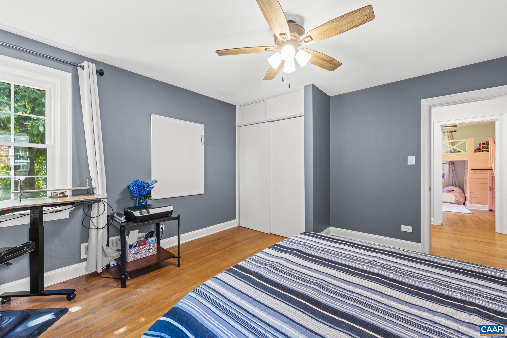 3304 Keswick Road Keswick, VA 22947 - Photo 21 of 38 a bedroom with a bed and a chandelier