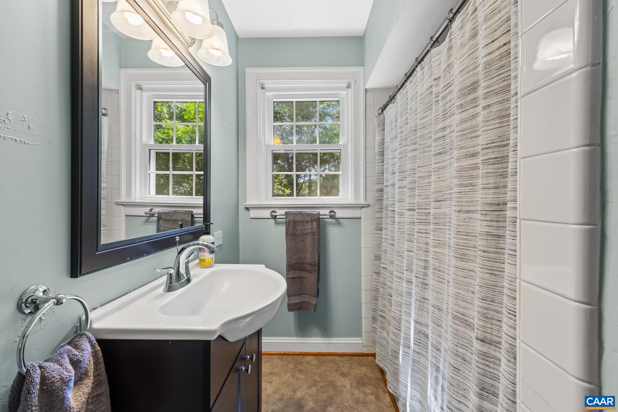 3304 Keswick Road Keswick, VA 22947 - Photo 23 of 38 a bathroom with a sink and a window