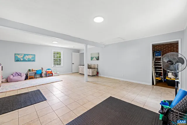 a view of a livingroom with furniture and toys