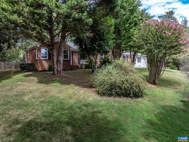 a tree in front of a white house