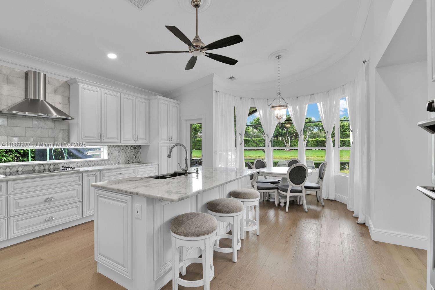 a open kitchen with a table chairs and white cabinets