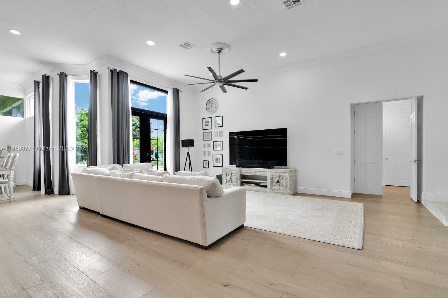 6622 Newport Lake Circle Boca Raton, FL 33496 - Photo 12 of 30 a living room with furniture and a flat screen tv