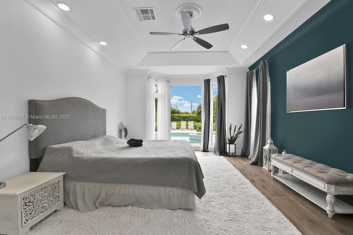 6622 Newport Lake Circle Boca Raton, FL 33496 - Photo 13 of 30 a bedroom with a bed ceiling fan and a large window