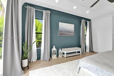 a bedroom with a bed and a large mirror