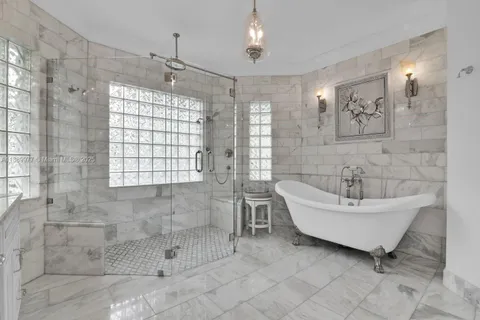 a bathroom with a bathtub sink and window