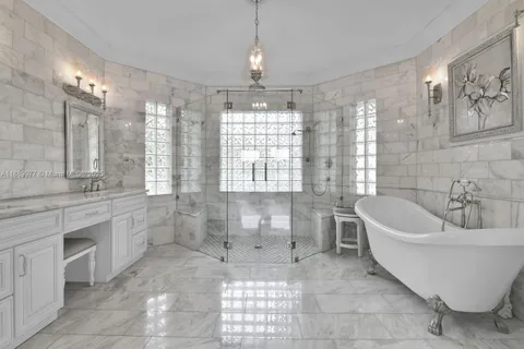 a spacious bathroom with a large tub shower and sink