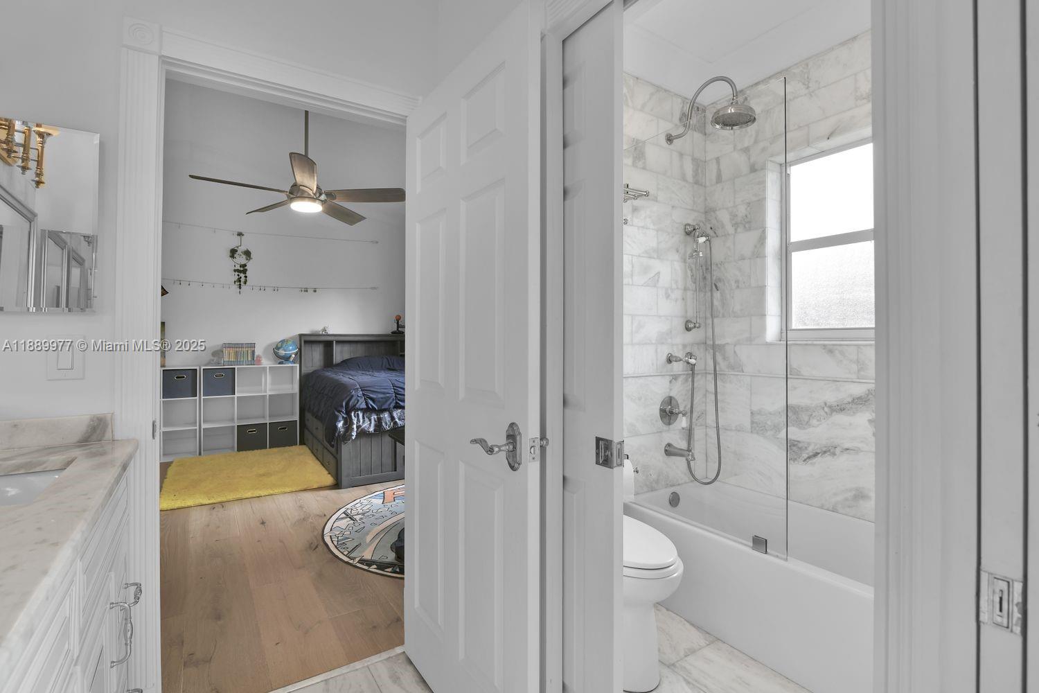 6622 Newport Lake Circle Boca Raton, FL 33496 - Photo 21 of 30 a bathroom with a sink a toilet and shower