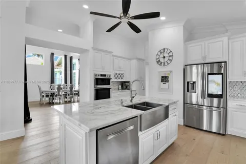 a kitchen with granite countertop a refrigerator and a stove