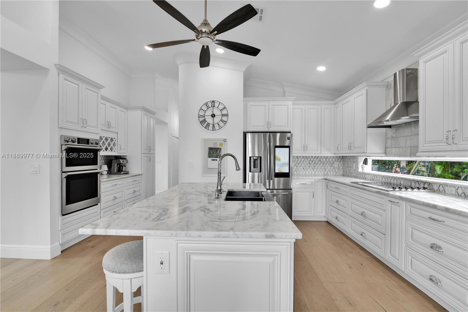 6622 Newport Lake Circle Boca Raton, FL 33496 - Photo 10 of 30 a kitchen with kitchen island a counter top space appliances and cabinets