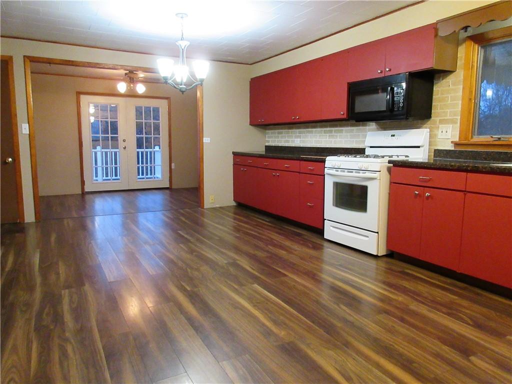 993 Bartley Road Parker, PA 16049 - Photo 3 of 25 a kitchen with stainless steel appliances kitchen island granite countertop a stove a sink and a microwave