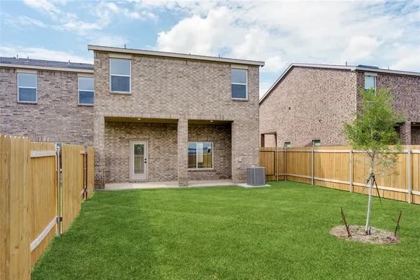 a view of a house with a yard and a garden