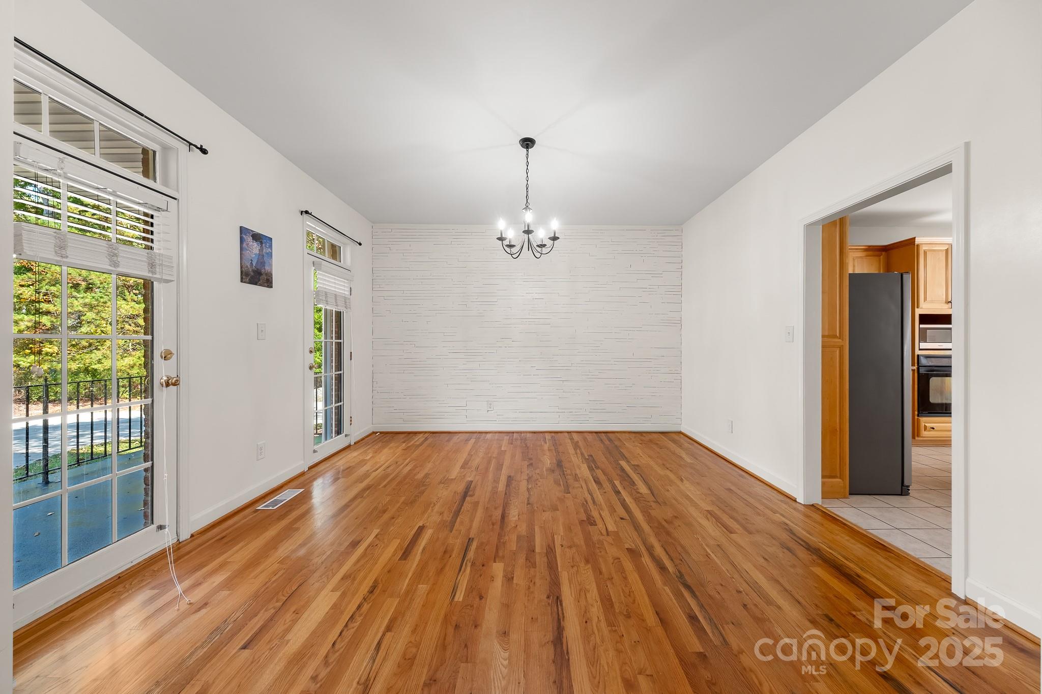 1713 Oak Park Court Iron Station, NC 28080 - Photo 12 of 39 wooden floor in an empty room with a window
