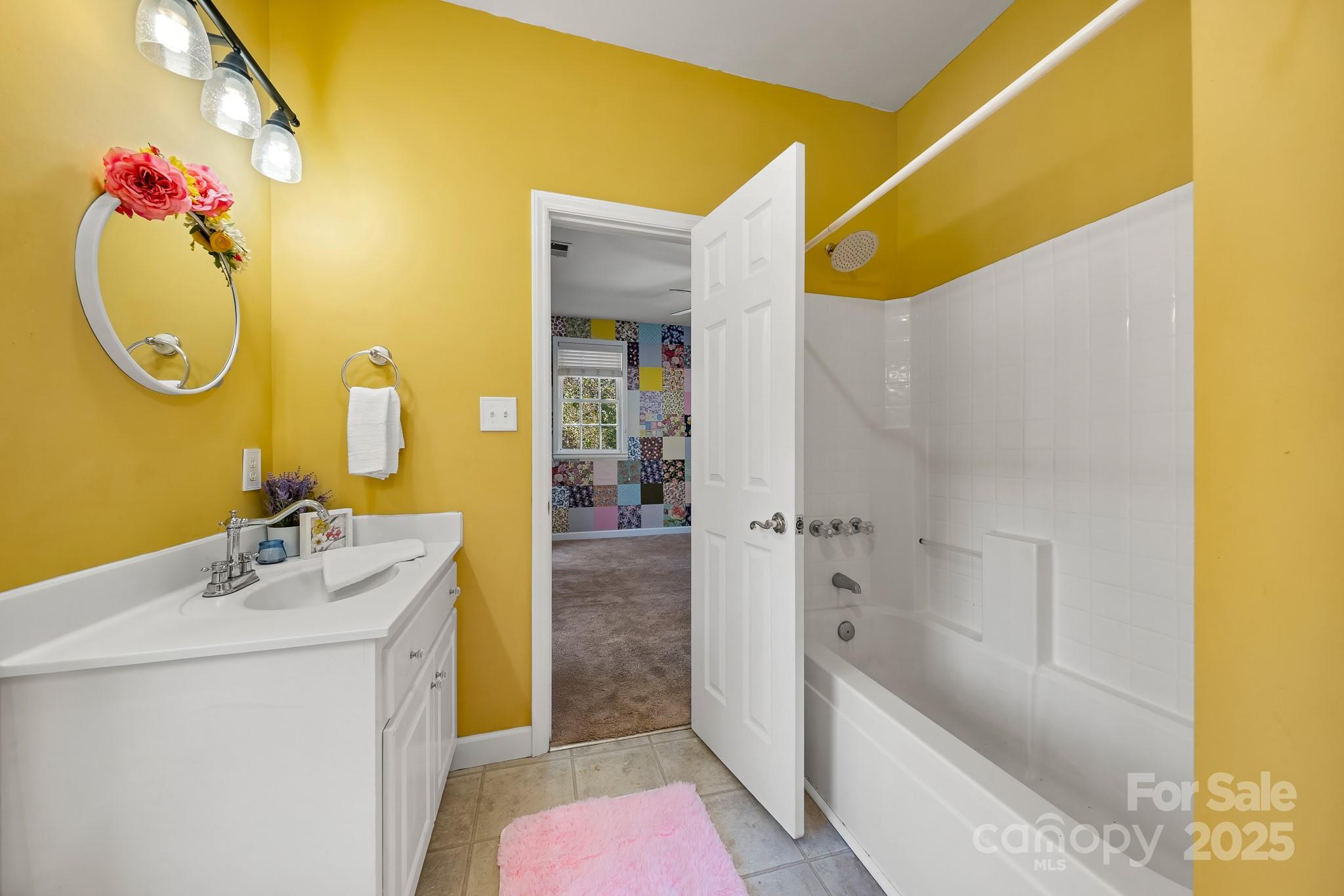 1713 Oak Park Court Iron Station, NC 28080 - Photo 35 of 39 a bathroom with a sink mirror and tub