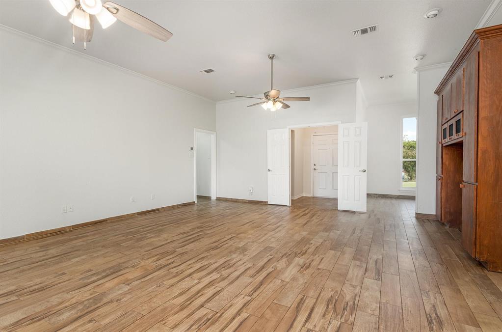 3961 Joe Wilson Road Midlothian, TX 76065 - Photo 11 of 27 a view of an empty room with wooden floor