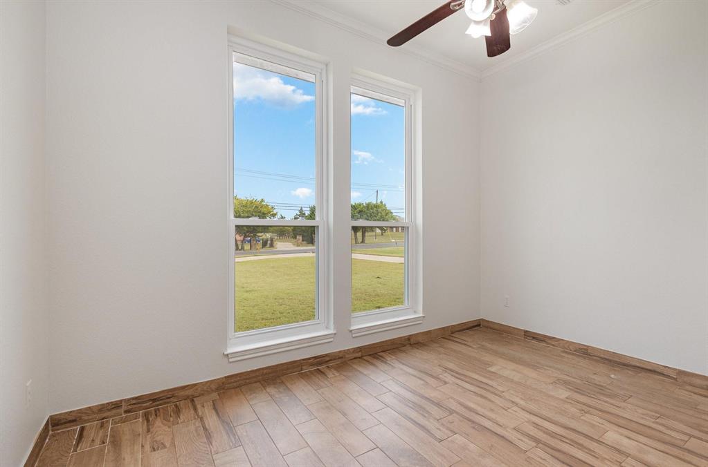 3961 Joe Wilson Road Midlothian, TX 76065 - Photo 12 of 27 an empty room with a window and wooden floor