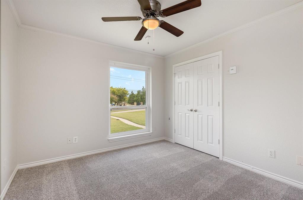 3961 Joe Wilson Road Midlothian, TX 76065 - Photo 18 of 27 an empty room with chandelier fan and windows