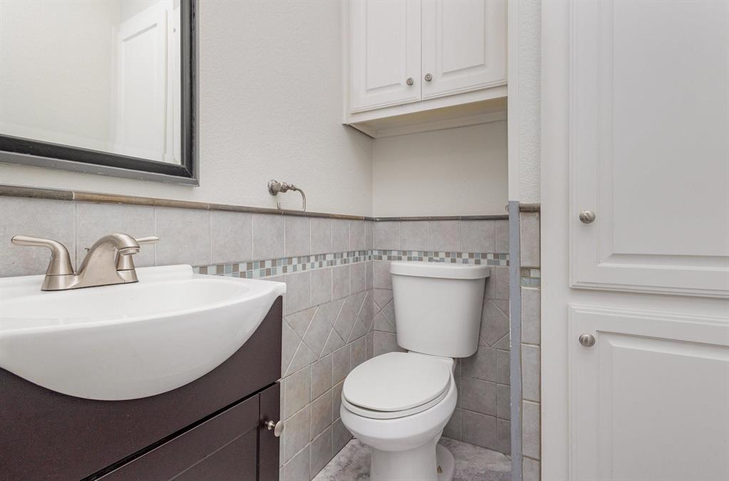 3961 Joe Wilson Road Midlothian, TX 76065 - Photo 21 of 27 a bathroom with a sink a toilet and mirror