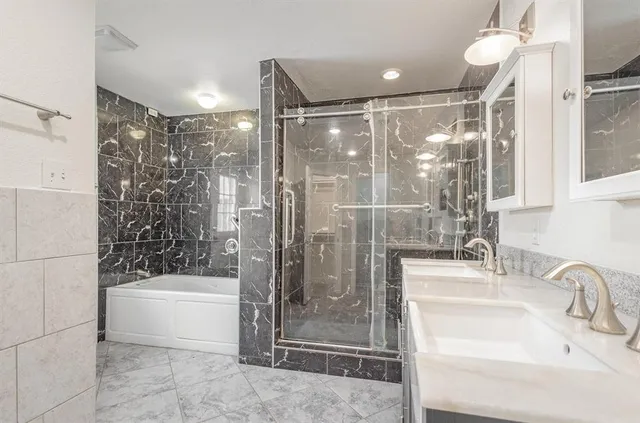a bathroom with a shower and a sink