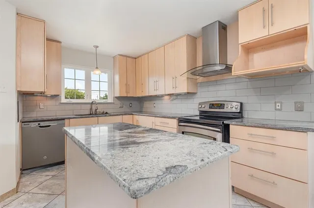 a kitchen with stainless steel appliances granite countertop a sink stove and cabinets