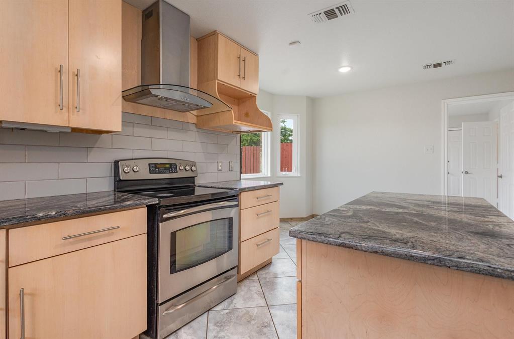 3961 Joe Wilson Road Midlothian, TX 76065 - Photo 5 of 27 a kitchen with granite countertop cabinets stainless steel appliances and sink