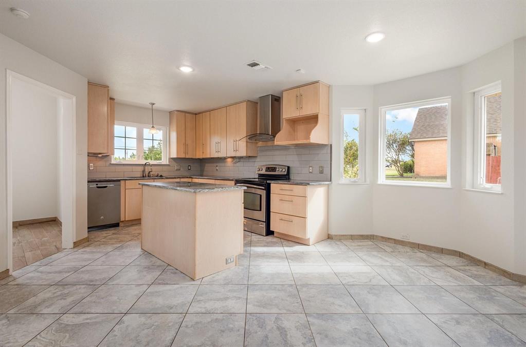 3961 Joe Wilson Road Midlothian, TX 76065 - Photo 6 of 27 a kitchen with stainless steel appliances granite countertop a stove sink and cabinets