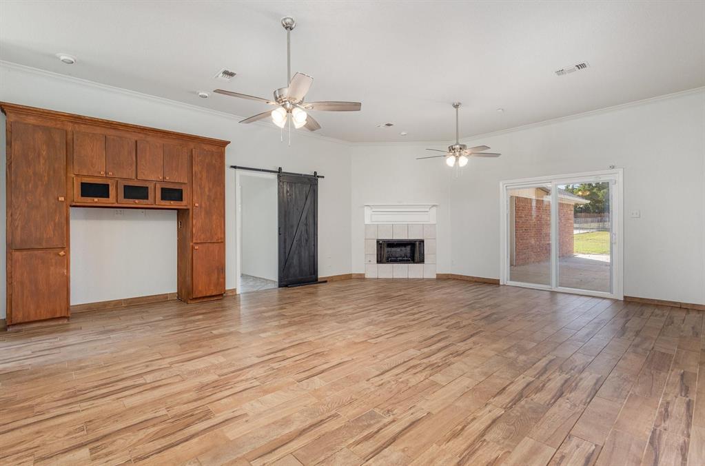 3961 Joe Wilson Road Midlothian, TX 76065 - Photo 10 of 27 a view of empty room with wooden floor and kitchen view