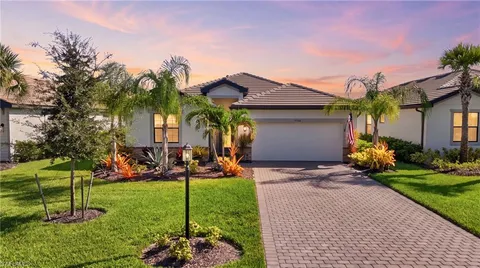 a view of a house with a yard and plants