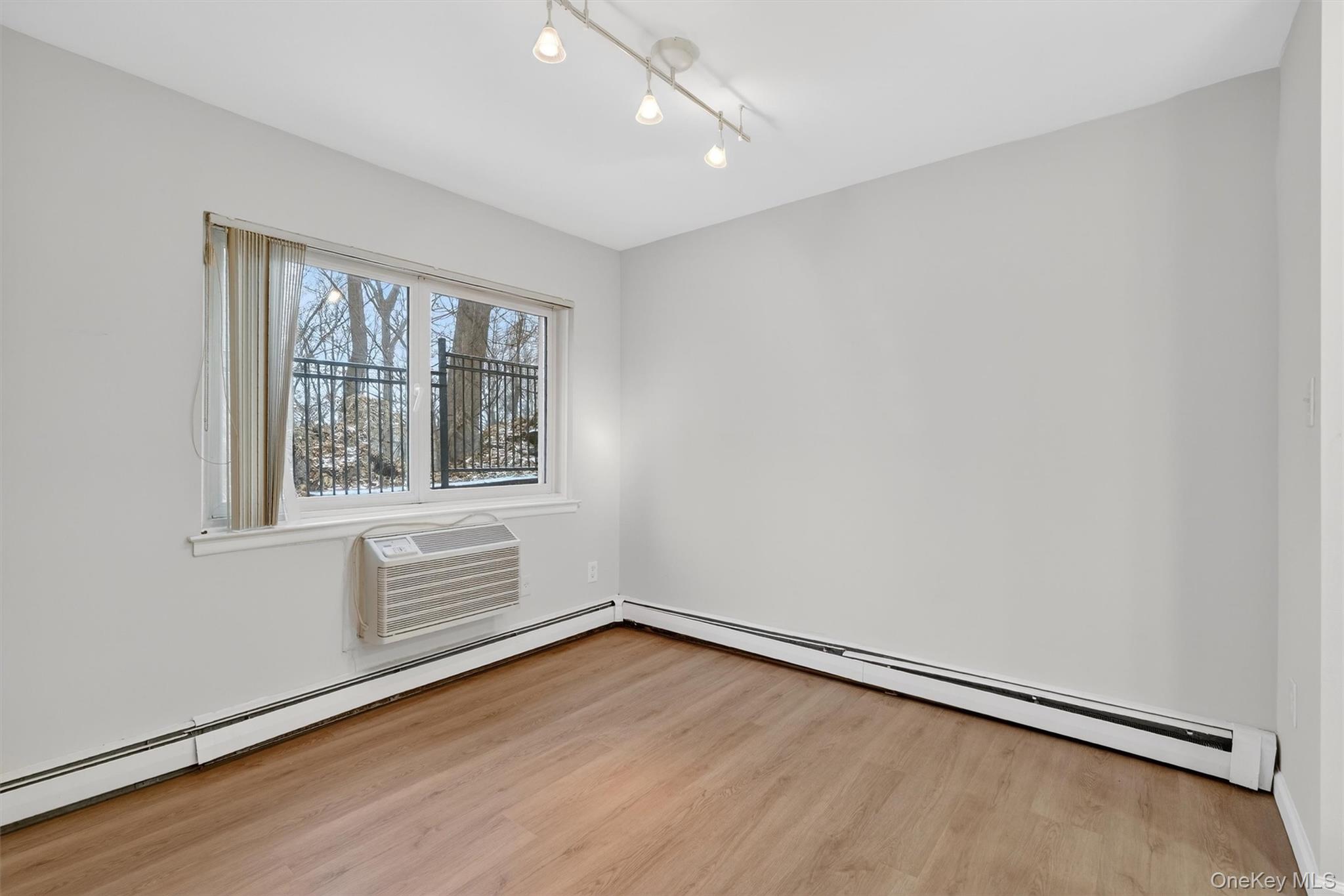 14 Scenic Drive, Unit 14T Croton-on-Hudson, NY 10520 - Photo 12 of 29 an empty room with wooden floor and windows