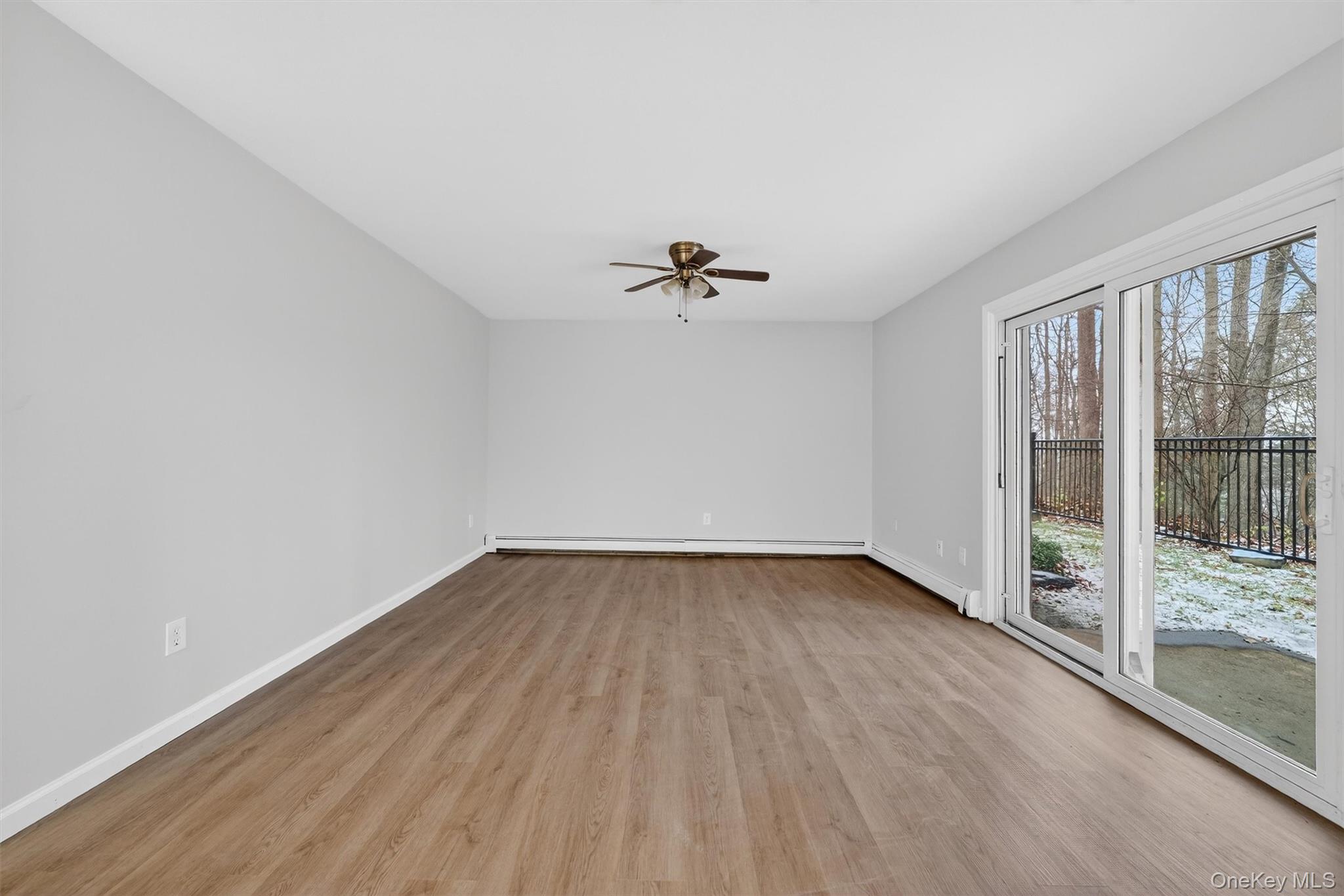 14 Scenic Drive, Unit 14T Croton-on-Hudson, NY 10520 - Photo 17 of 29 an empty room with wooden floor and windows